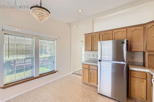 4578 Gray Fox Hts Unit 52, Colorado Springs, CO 80922 - kitchen with freestanding refrigerator, a chandelier, light countertops, recessed lighting, and pendant lighting