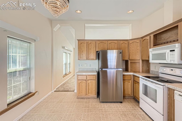 4578 Gray Fox Hts Unit 52, Colorado Springs, CO 80922 - kitchen with white appliances, light countertops, a chandelier, and recessed lighting