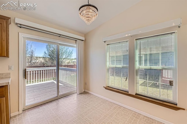 4578 Gray Fox Hts Unit 52, Colorado Springs, CO 80922 - unfurnished dining area with baseboards and a chandelier