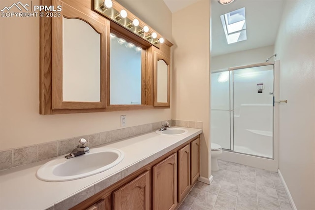 4578 Gray Fox Hts Unit 52, Colorado Springs, CO 80922 - full bathroom featuring a skylight, a shower stall, and double vanity
