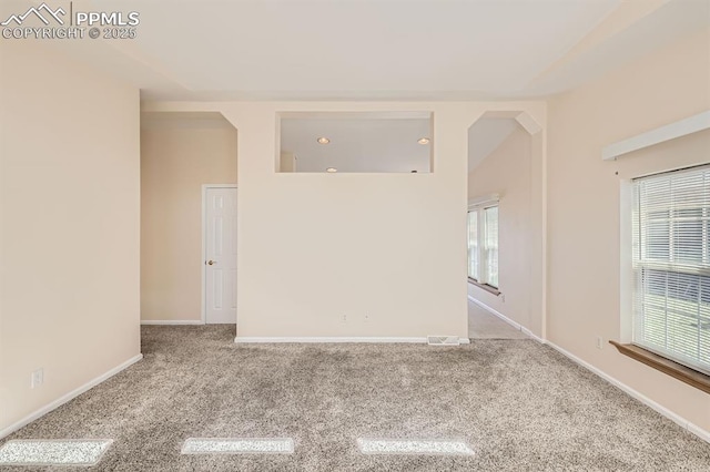 4578 Gray Fox Hts Unit 52, Colorado Springs, CO 80922 - carpeted empty room with healthy amount of natural light and arched walkways