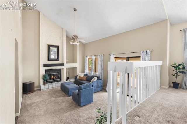 carpeted living room featuring a tile fireplace, high vaulted ceiling, ceiling fan, and baseboards