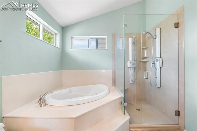 bathroom with a shower stall, a garden tub, and vaulted ceiling