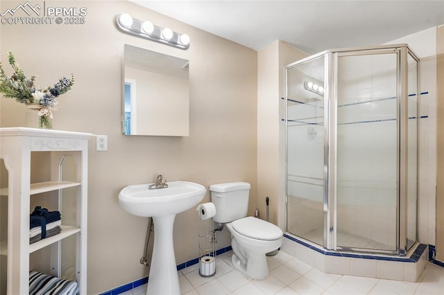 full bathroom featuring a stall shower, toilet, and tile patterned floors