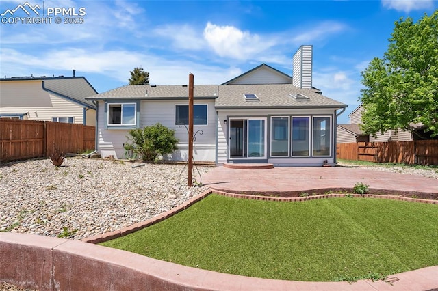 rear view of property featuring a patio area, a chimney, and a shingled roof
