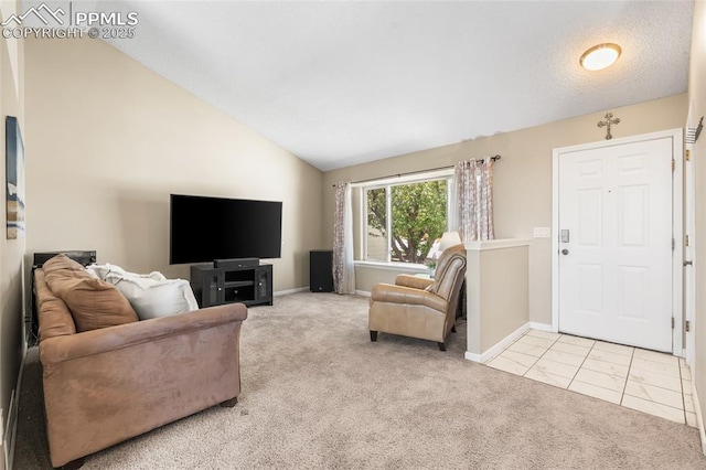 carpeted living room with vaulted ceiling and baseboards