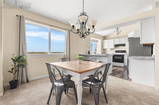 dining area with carpet, a chandelier, baseboards, and a textured ceiling