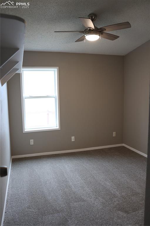 4663 Pine Marten Pt, Colorado Springs, CO 80922 - carpeted spare room featuring baseboards, ceiling fan, and a textured ceiling