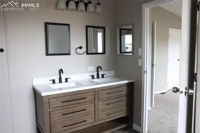 4663 Pine Marten Pt, Colorado Springs, CO 80922 - bathroom with double vanity, a sink, and baseboards