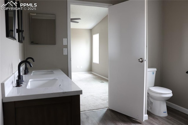 4663 Pine Marten Pt, Colorado Springs, CO 80922 - bathroom featuring baseboards, toilet, ceiling fan, and wood finished floors