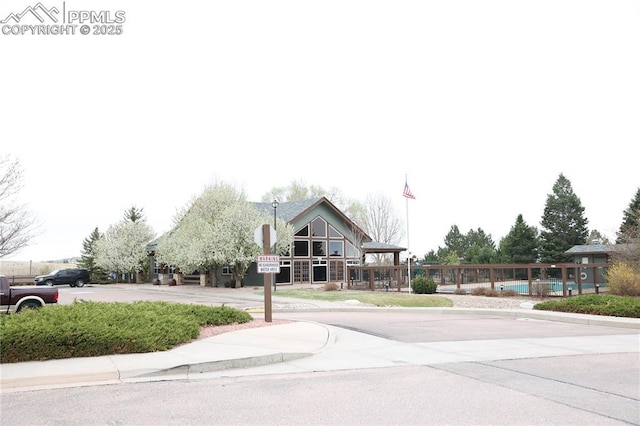 4663 Pine Marten Pt, Colorado Springs, CO 80922 - view of street featuring traffic signs, sidewalks, and curbs