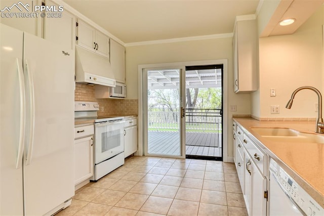 kitchen with light tile patterned floors, range hood, white appliances, a sink, and tasteful backsplash