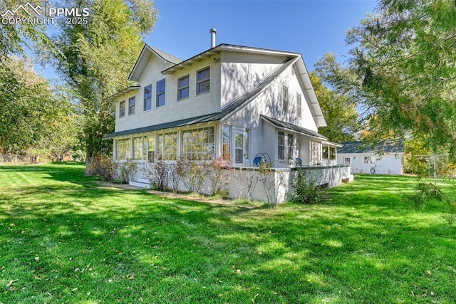 back of house featuring a yard