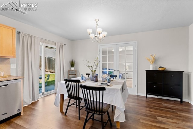 dining space featuring a chandelier, french doors, and dark wood-type flooring
