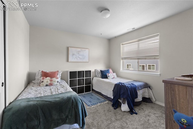 bedroom with carpet floors, baseboards, and visible vents