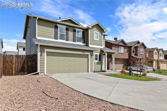 view of front of property with concrete driveway, an attached garage, fence, and a residential view