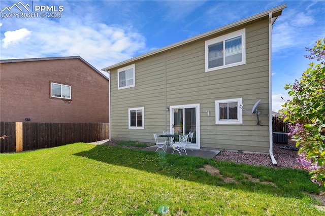 back of property with a lawn, fence, and a patio