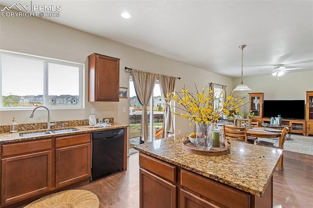 kitchen featuring wood finished floors, a sink, black dishwasher, and open floor plan