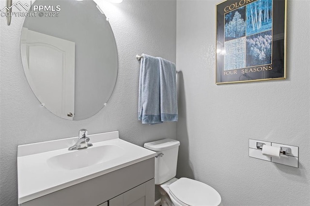 bathroom with toilet and vanity