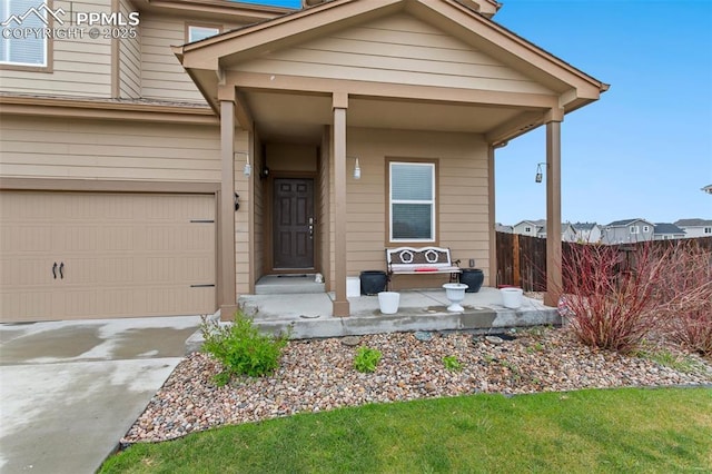 view of front of house featuring a garage, fence, and driveway