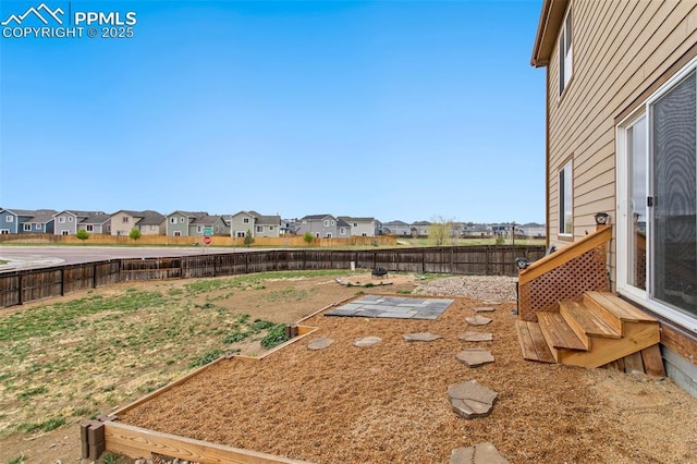 view of yard featuring a residential view and a fenced backyard