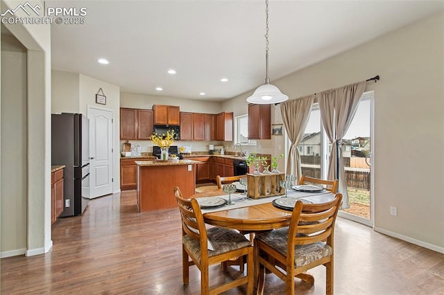 dining area with baseboards, recessed lighting, and wood finished floors