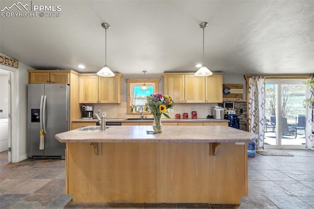 3235 S Meridian Rd, Colorado Springs, CO 80929 - kitchen with stainless steel fridge, light countertops, a wealth of natural light, and stone tile floors