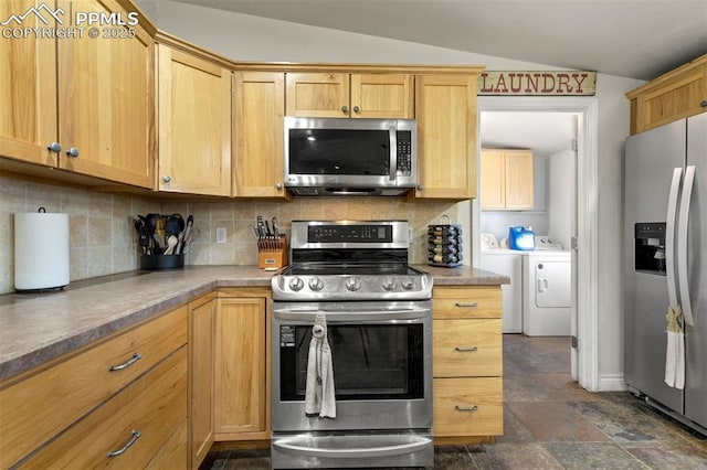 3235 S Meridian Rd, Colorado Springs, CO 80929 - kitchen featuring stainless steel appliances, separate washer and dryer, decorative backsplash, and lofted ceiling