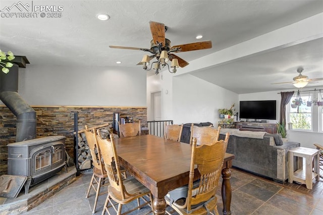 3235 S Meridian Rd, Colorado Springs, CO 80929 - dining space with recessed lighting, a wood stove, ceiling fan, and beam ceiling