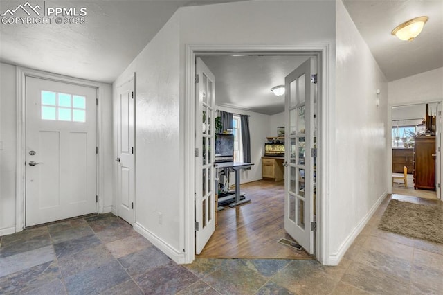 3235 S Meridian Rd, Colorado Springs, CO 80929 - entryway featuring baseboards and stone tile flooring