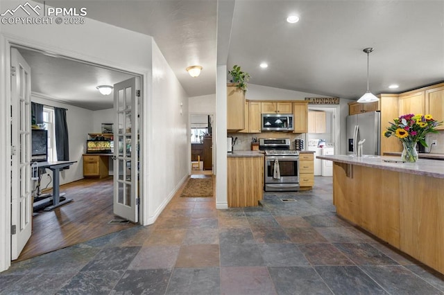 3235 S Meridian Rd, Colorado Springs, CO 80929 - kitchen with light countertops, light brown cabinets, stainless steel appliances, and lofted ceiling