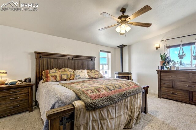 3235 S Meridian Rd, Colorado Springs, CO 80929 - bedroom featuring multiple windows, lofted ceiling, ceiling fan, and light colored carpet