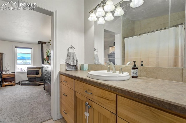 3235 S Meridian Rd, Colorado Springs, CO 80929 - ensuite bathroom featuring vanity, a wood stove, and ensuite bath