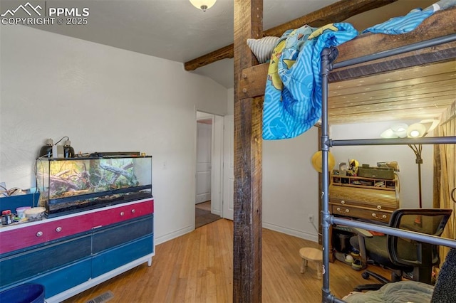 3235 S Meridian Rd, Colorado Springs, CO 80929 - bedroom with baseboards, wood finished floors, and beamed ceiling