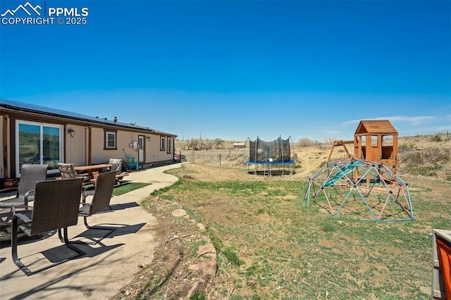3235 S Meridian Rd, Colorado Springs, CO 80929 - view of yard with a playground, a trampoline, and a patio