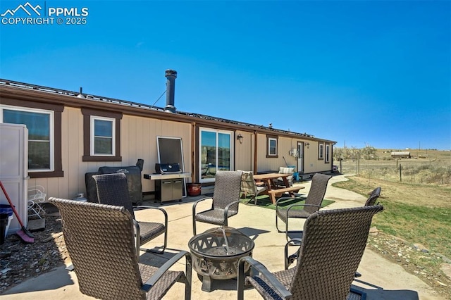 3235 S Meridian Rd, Colorado Springs, CO 80929 - back of property featuring a fire pit, a patio area, and fence