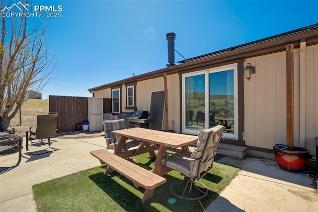 3235 S Meridian Rd, Colorado Springs, CO 80929 - rear view of house with outdoor dining area, a patio area, and fence