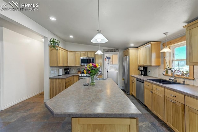 3235 S Meridian Rd, Colorado Springs, CO 80929 - kitchen featuring light brown cabinetry, washer / clothes dryer, stainless steel appliances, decorative backsplash, and a kitchen island