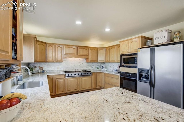 7850 Wilderness Dr, Colorado Springs, CO 80908 - kitchen with appliances with stainless steel finishes, a sink, light stone countertops, tasteful backsplash, and recessed lighting