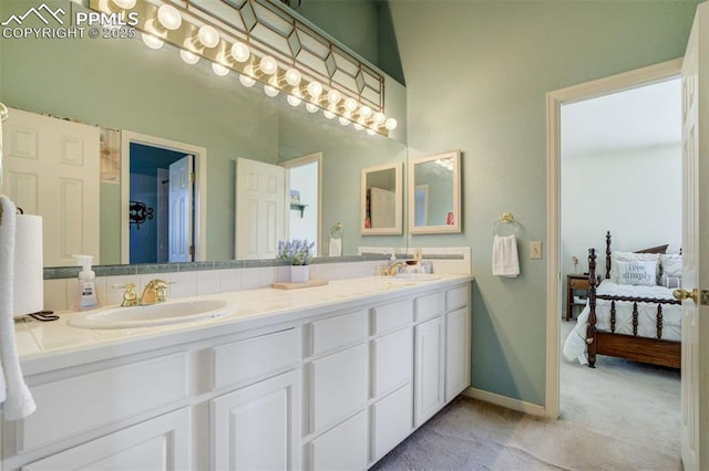 7850 Wilderness Dr, Colorado Springs, CO 80908 - ensuite bathroom featuring double vanity and baseboards