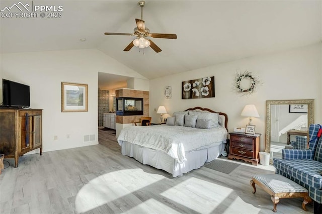 7850 Wilderness Dr, Colorado Springs, CO 80908 - bedroom featuring lofted ceiling, light wood finished floors, baseboards, a fireplace, and a ceiling fan