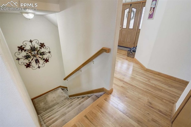 7850 Wilderness Dr, Colorado Springs, CO 80908 - stairs featuring wood finished floors and baseboards