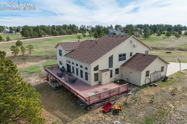 7850 Wilderness Dr, Colorado Springs, CO 80908 - back of property featuring a shingled roof, a wooden deck, and view of wooded area