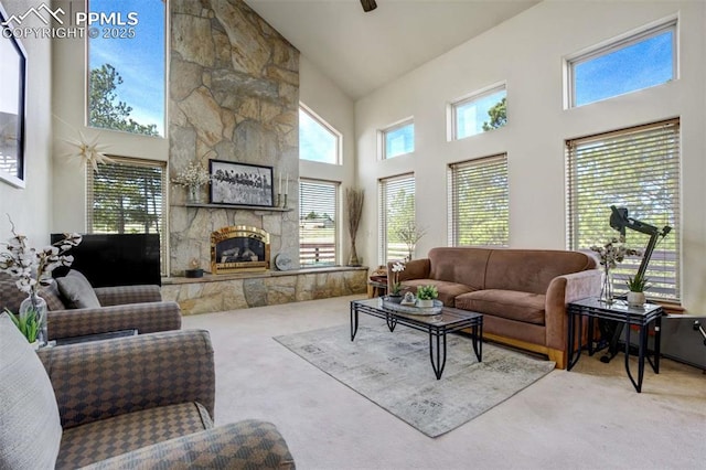 7850 Wilderness Dr, Colorado Springs, CO 80908 - carpeted living area featuring high vaulted ceiling and a fireplace