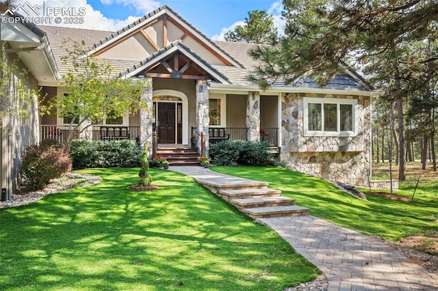 4415 Hidden Rock Rd, Colorado Springs, CO 80908 - view of front of property with stone siding, a porch, a front lawn, and stucco siding