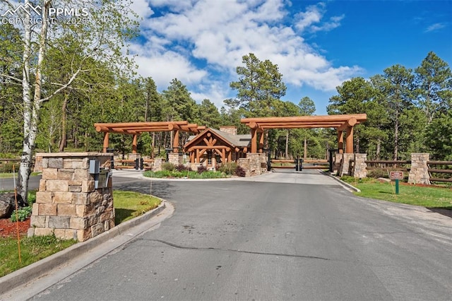 4415 Hidden Rock Rd, Colorado Springs, CO 80908 - view of asphalt street with a gated entry and curbs