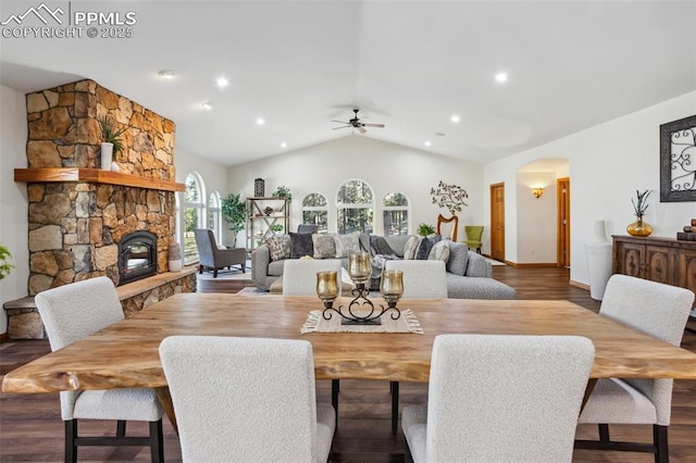 4415 Hidden Rock Rd, Colorado Springs, CO 80908 - dining room featuring arched walkways, a ceiling fan, lofted ceiling, a fireplace, and wood finished floors