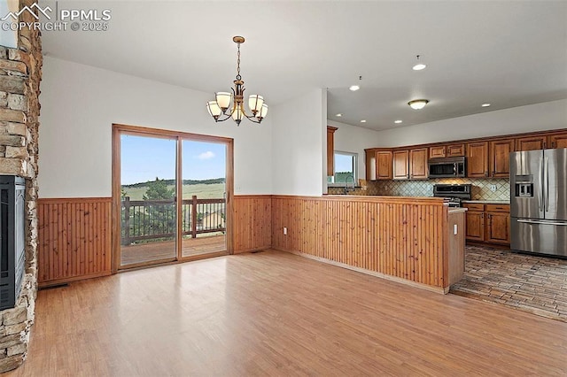 17880 Plains Edge Ct, Peyton, CO 80831 - kitchen featuring a wainscoted wall, stainless steel appliances, and light wood finished floors