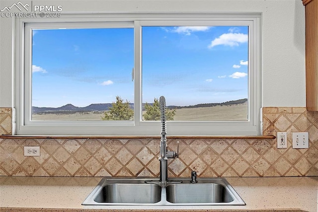 17880 Plains Edge Ct, Peyton, CO 80831 - kitchen with light countertops, decorative backsplash, and a sink