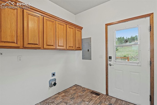 17880 Plains Edge Ct, Peyton, CO 80831 - laundry room featuring visible vents, brick floor, electric panel, electric dryer hookup, and cabinet space
